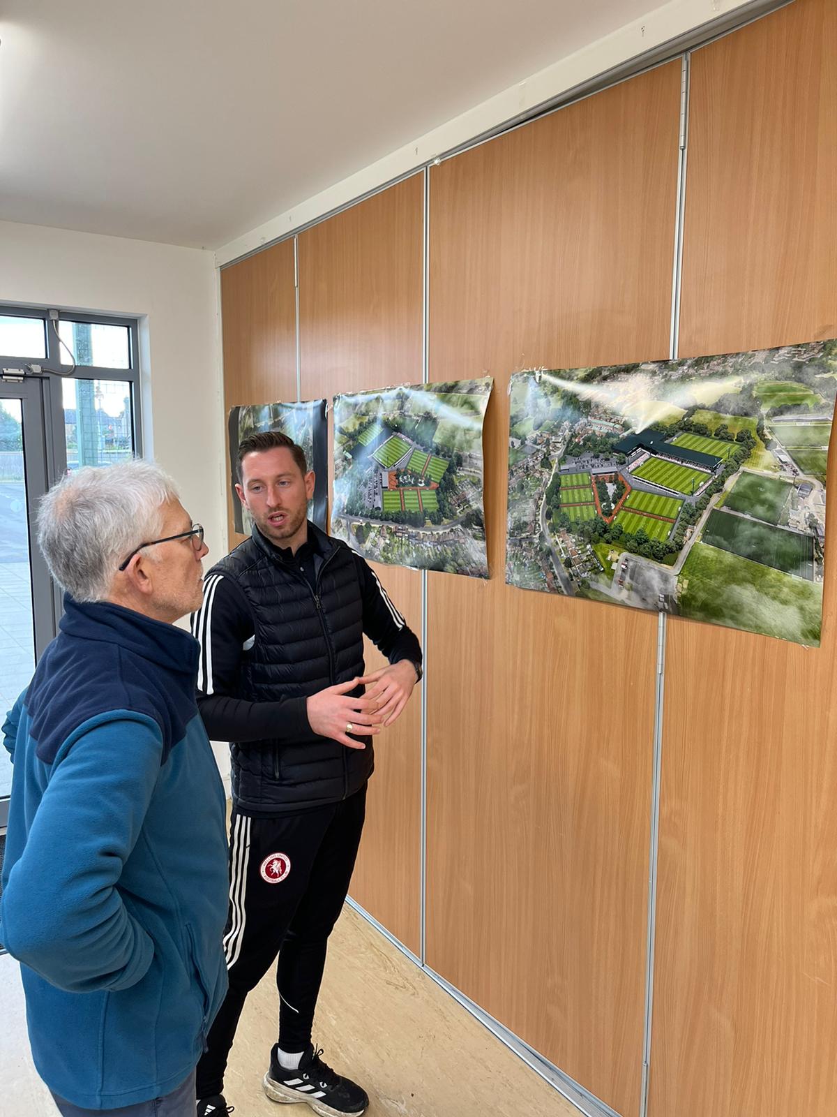 Tom McNamee of AFC Greenwich Borough discusses GB10 site plans with a local resident during a community consultation