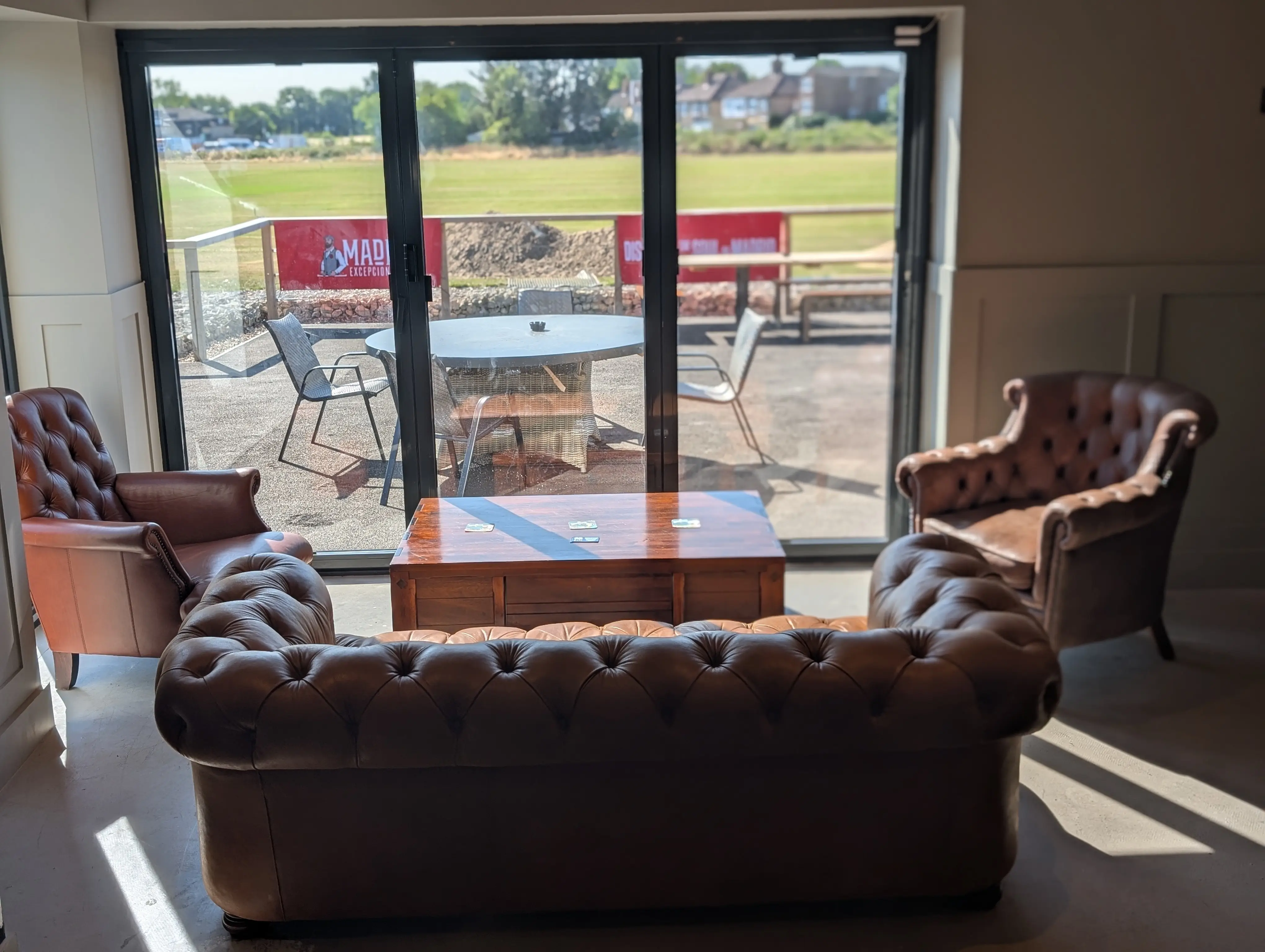 Bar seating area with stools and pendant lights inside GB10 Eltham event space.