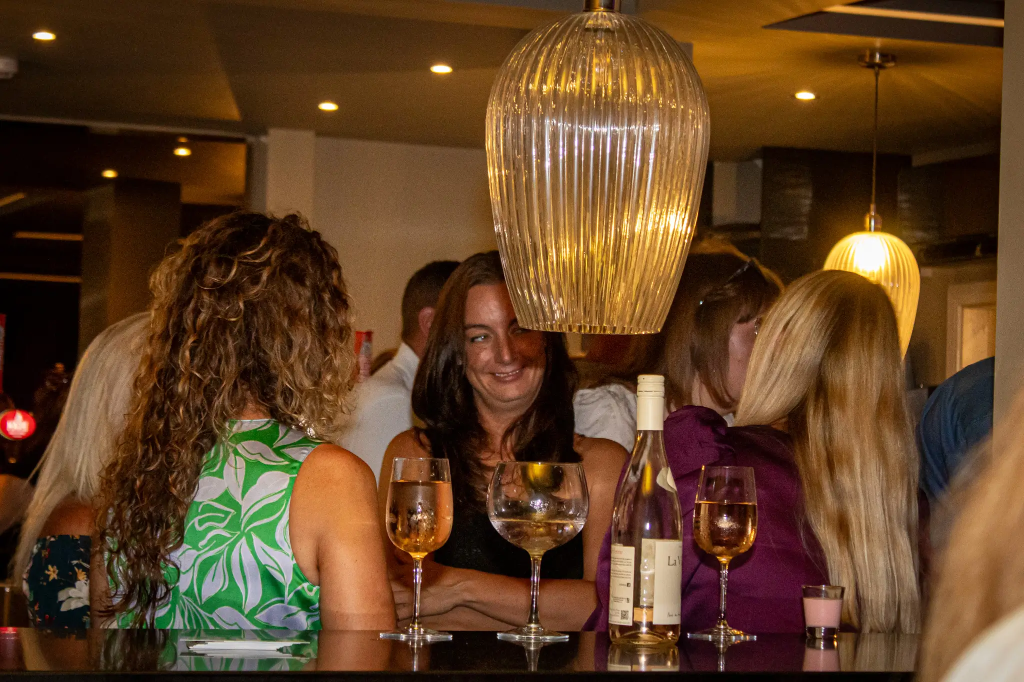Bar seating area with stools and pendant lights inside GB10 Eltham event space.