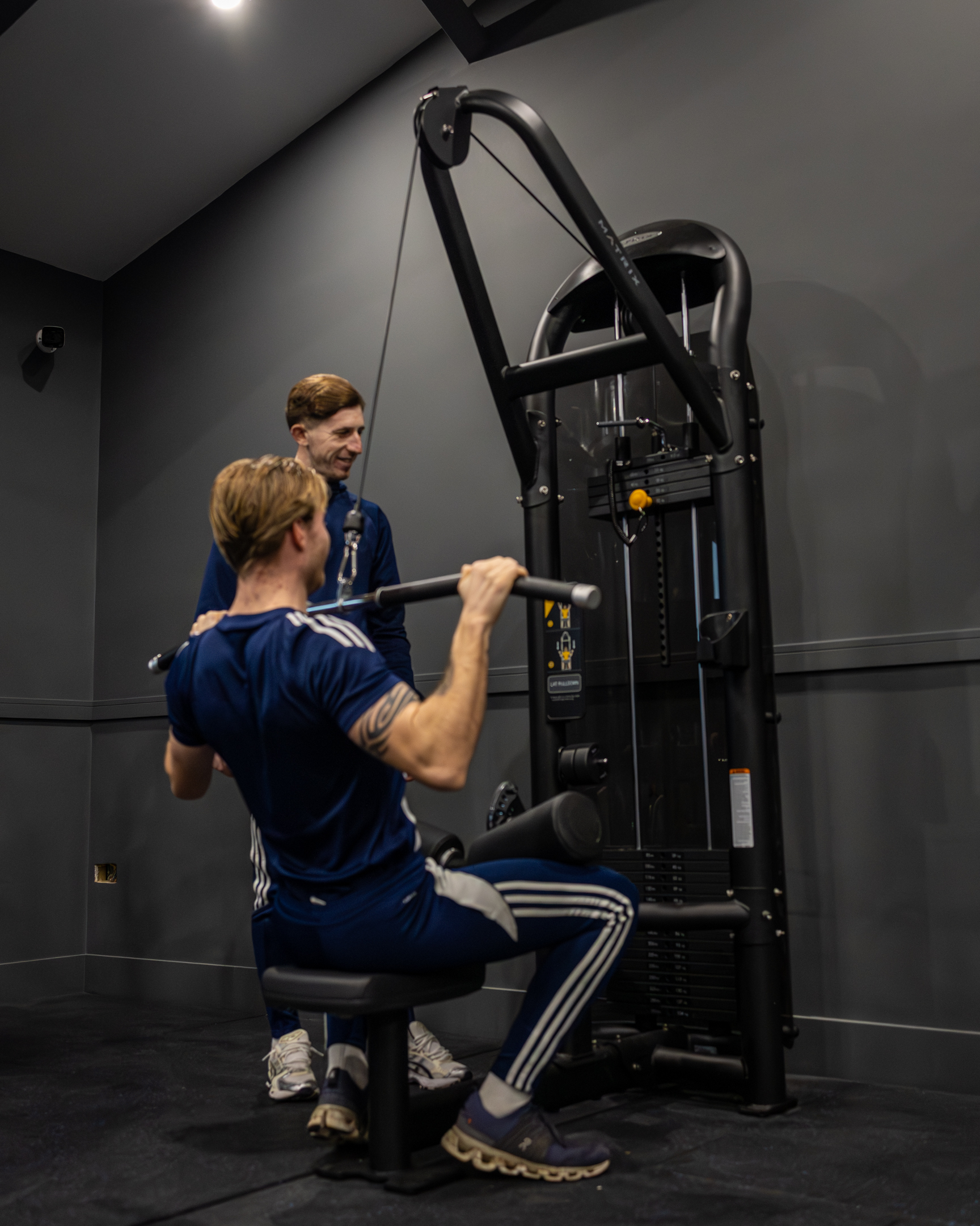 Bar seating area with stools and pendant lights inside GB10 Eltham event space.