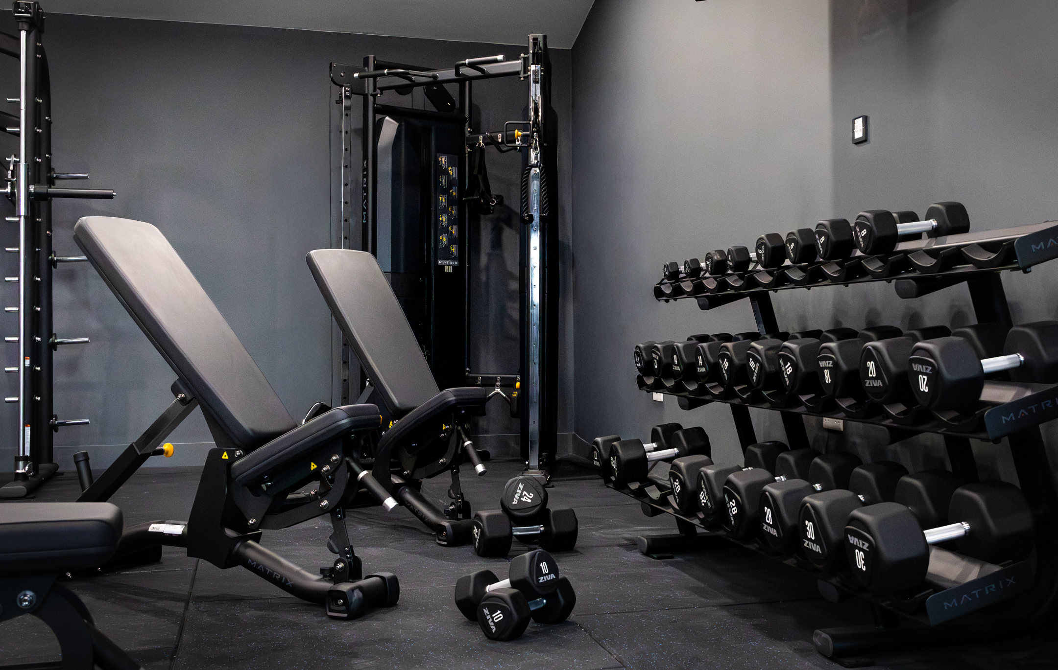 Bar seating area with stools and pendant lights inside GB10 Eltham event space.