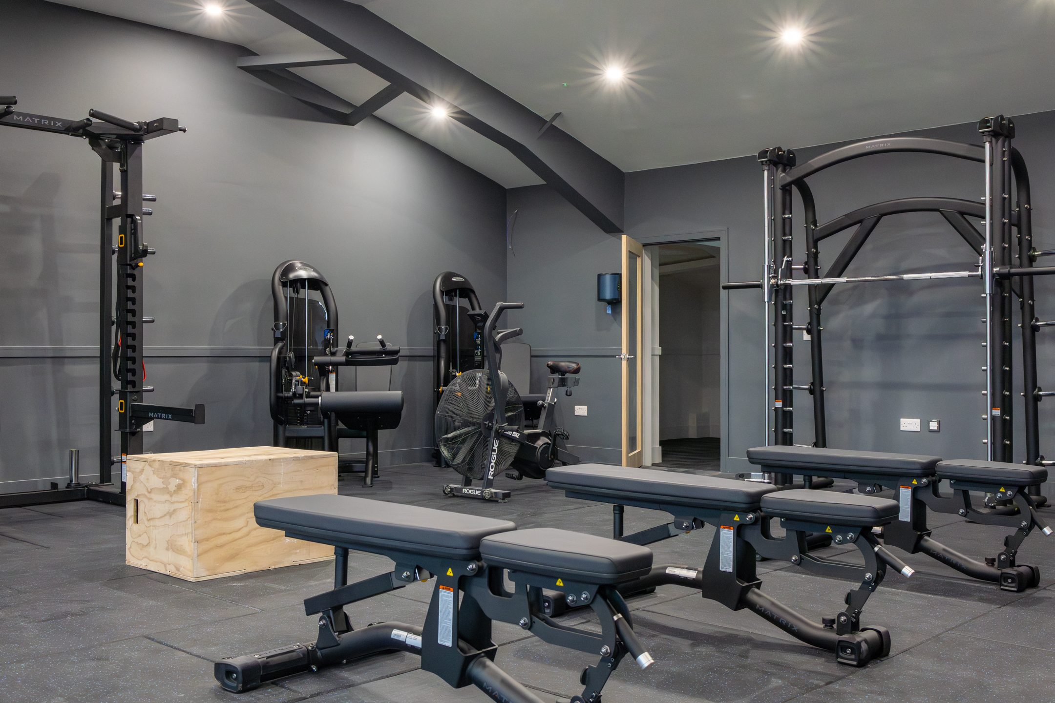 Bar seating area with stools and pendant lights inside GB10 Eltham event space.