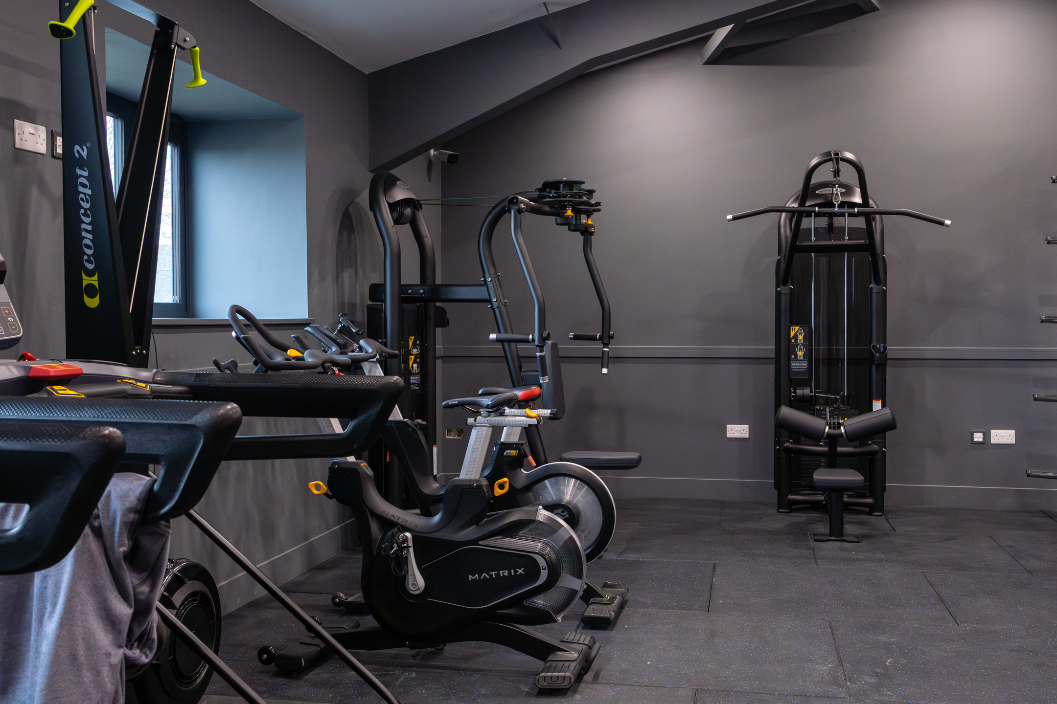 Bar seating area with stools and pendant lights inside GB10 Eltham event space.