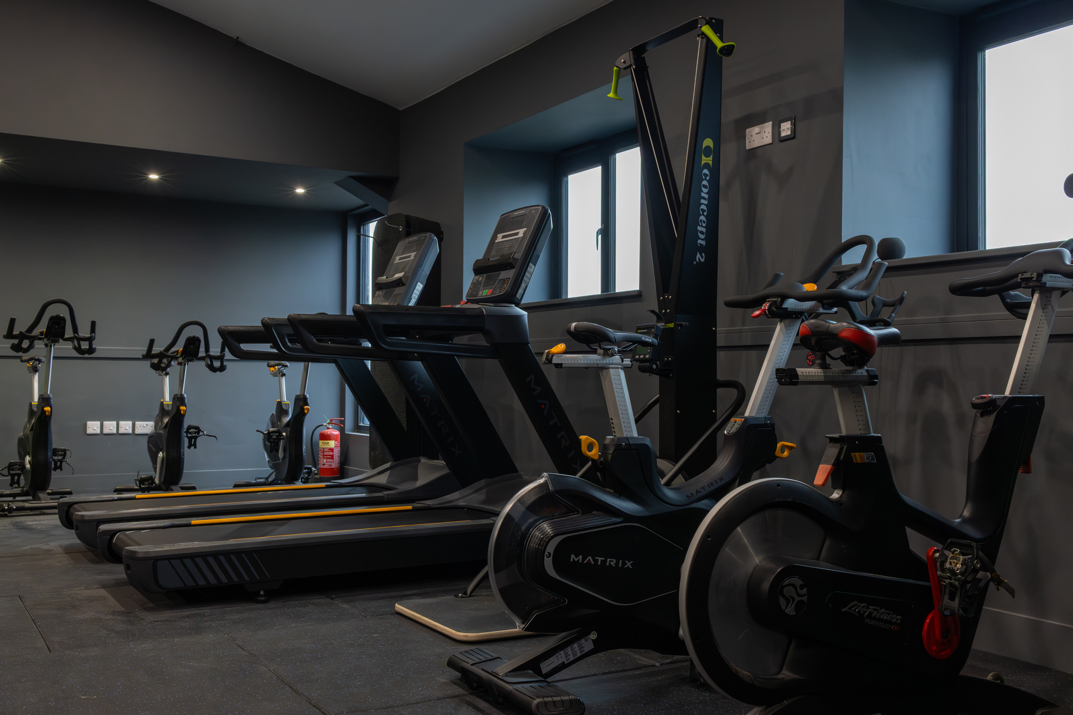 View of GB10 Eltham Hall with double doors opening onto outdoor terrace seating.